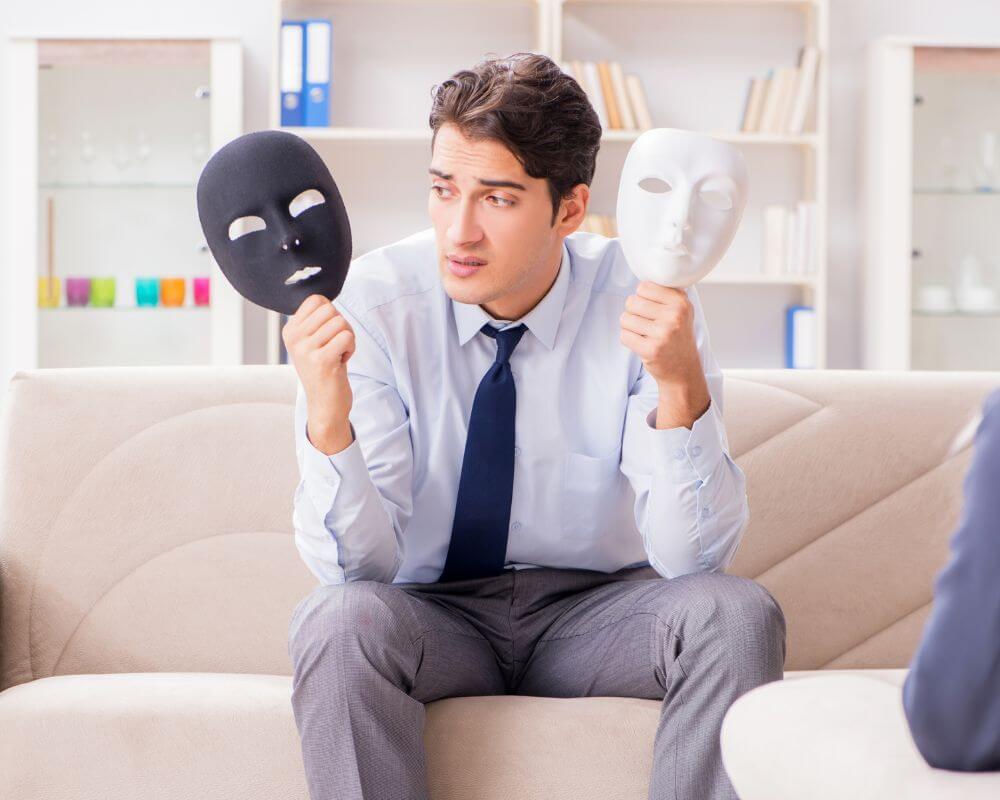 a narcissist person holding two masks in his hands