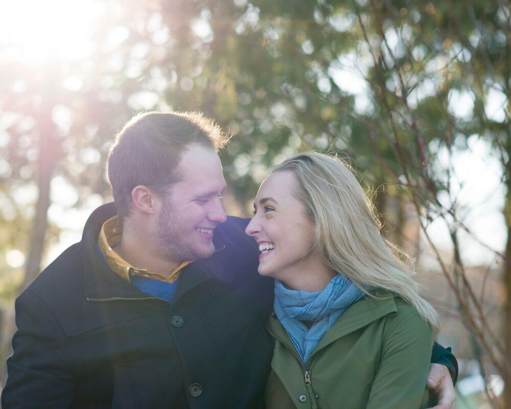 a very happy couple smiling at each other