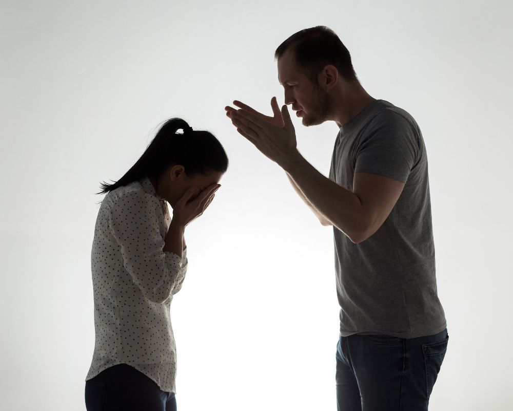 a man shouting at a woman making her uncomfortable