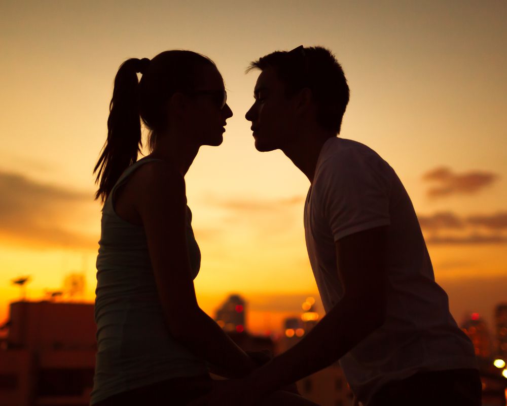 a couple sharing a romantic moment at sunset