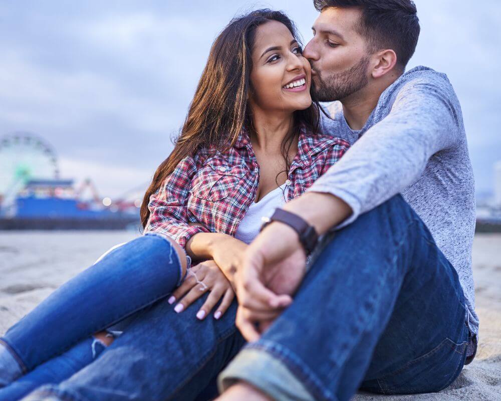 a man kissing a woman on the cheeks affectionately