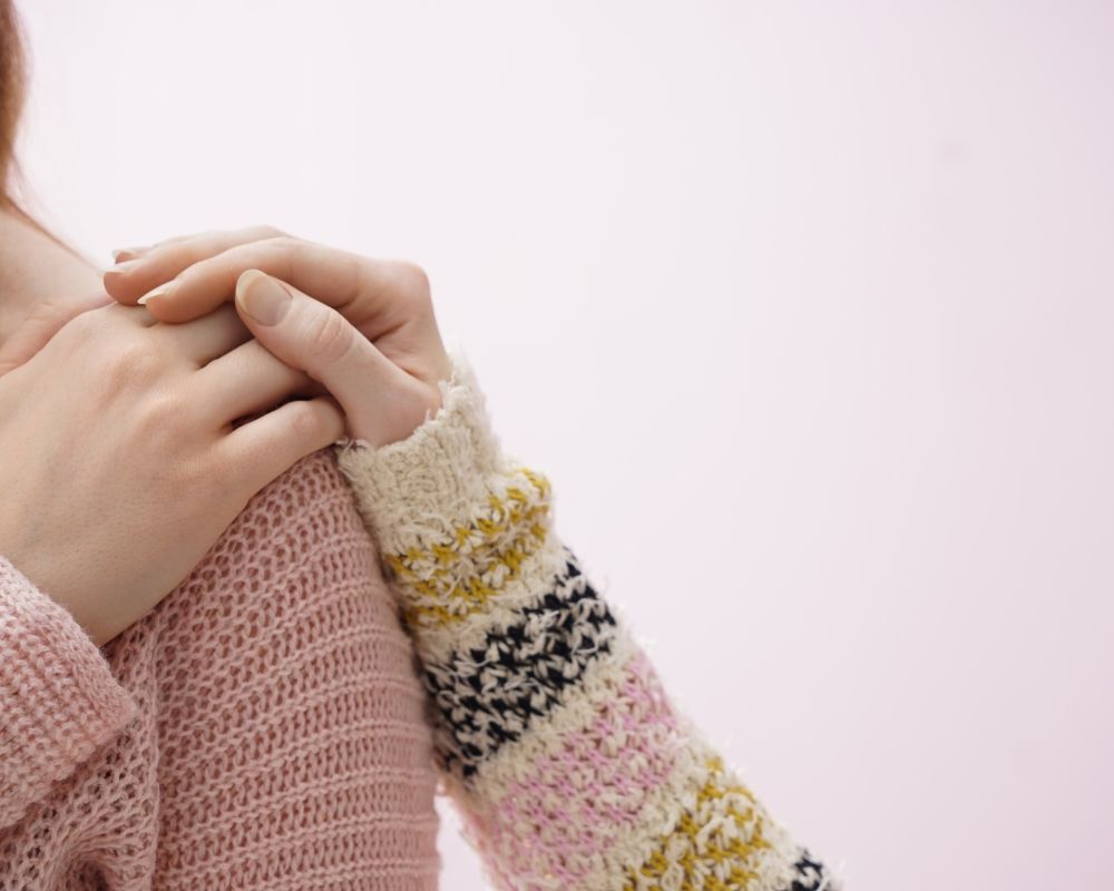 woman keeping hand's on a woman shoulder as a sign of empathy