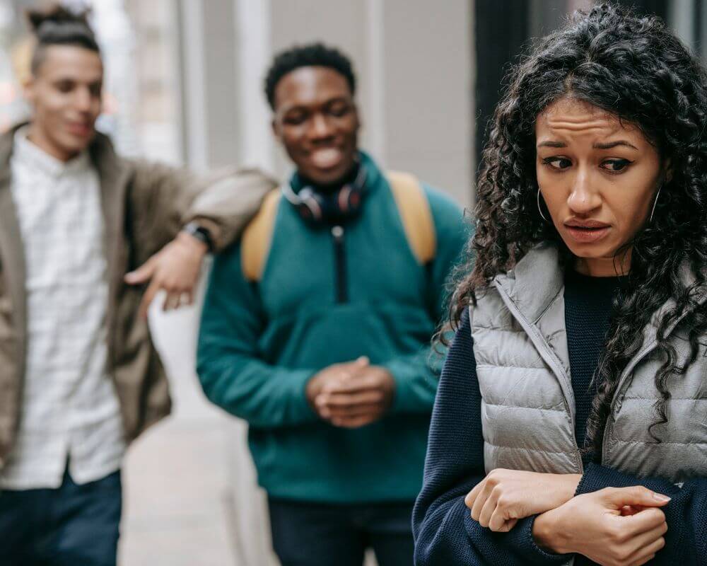 a woman being intimidated by couple of boys staring at her