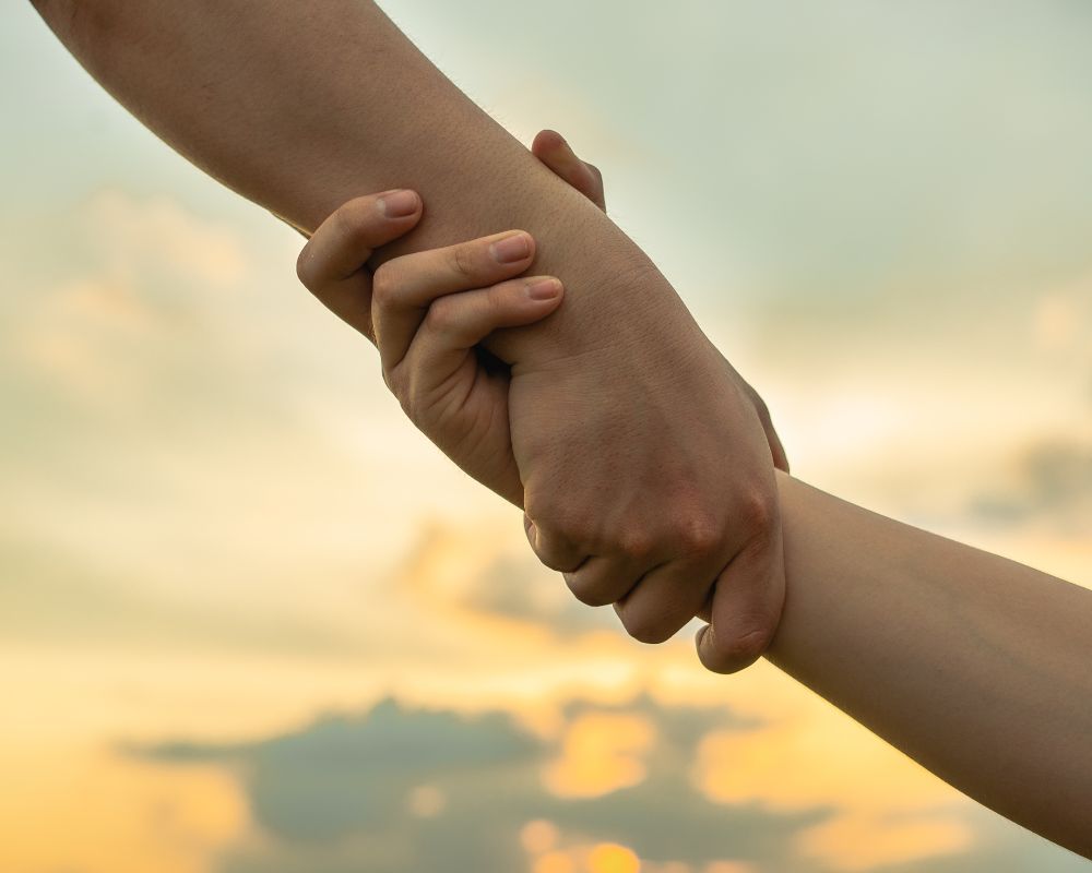 compassionate gesture among a couple via holding hands