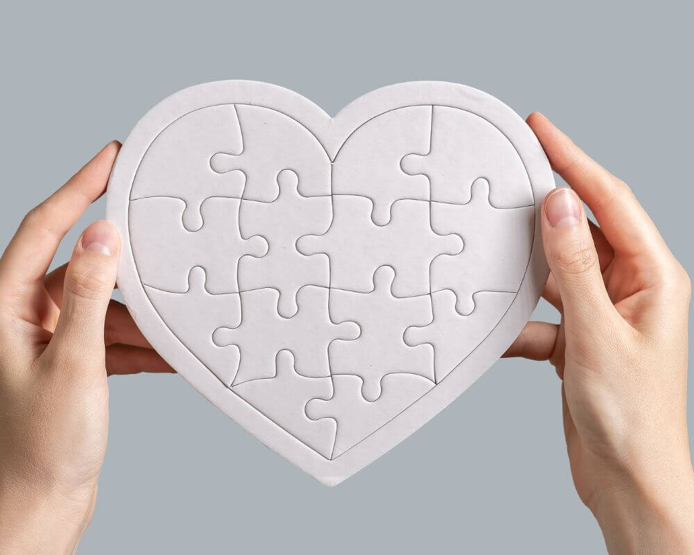 a gesture of keeping a relationship strong by keeping all the pieces of a heart puzzle together