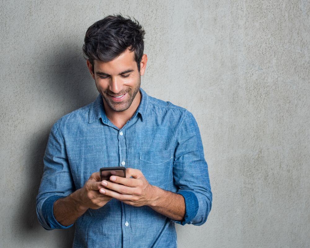 man texting and smiling