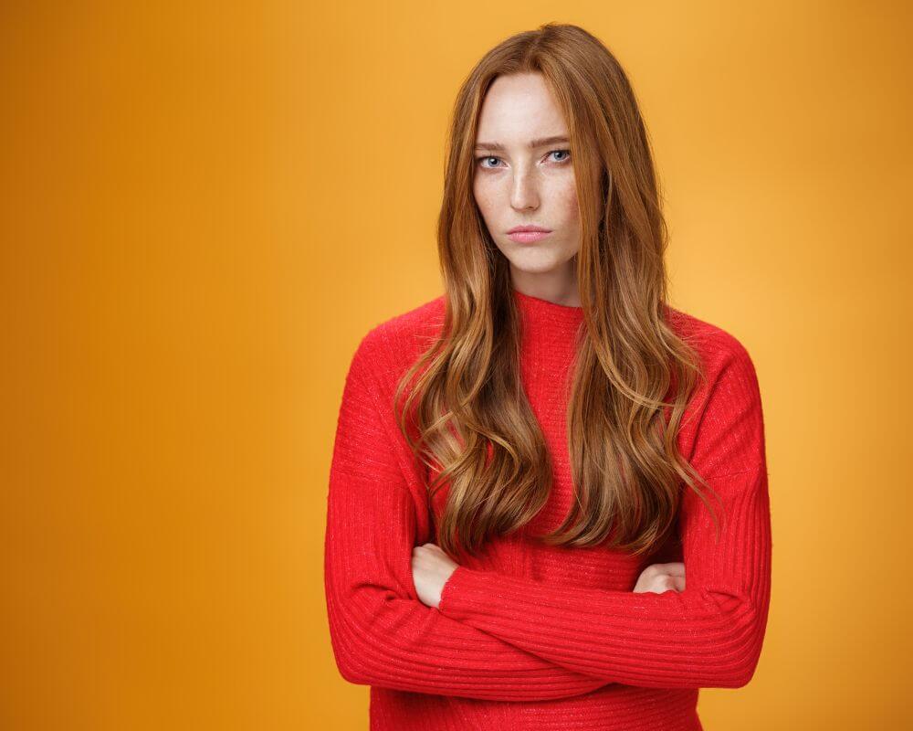 a woman standing and staring passive aggressively